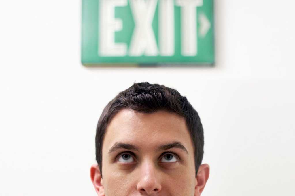 man looking at exit quit termination